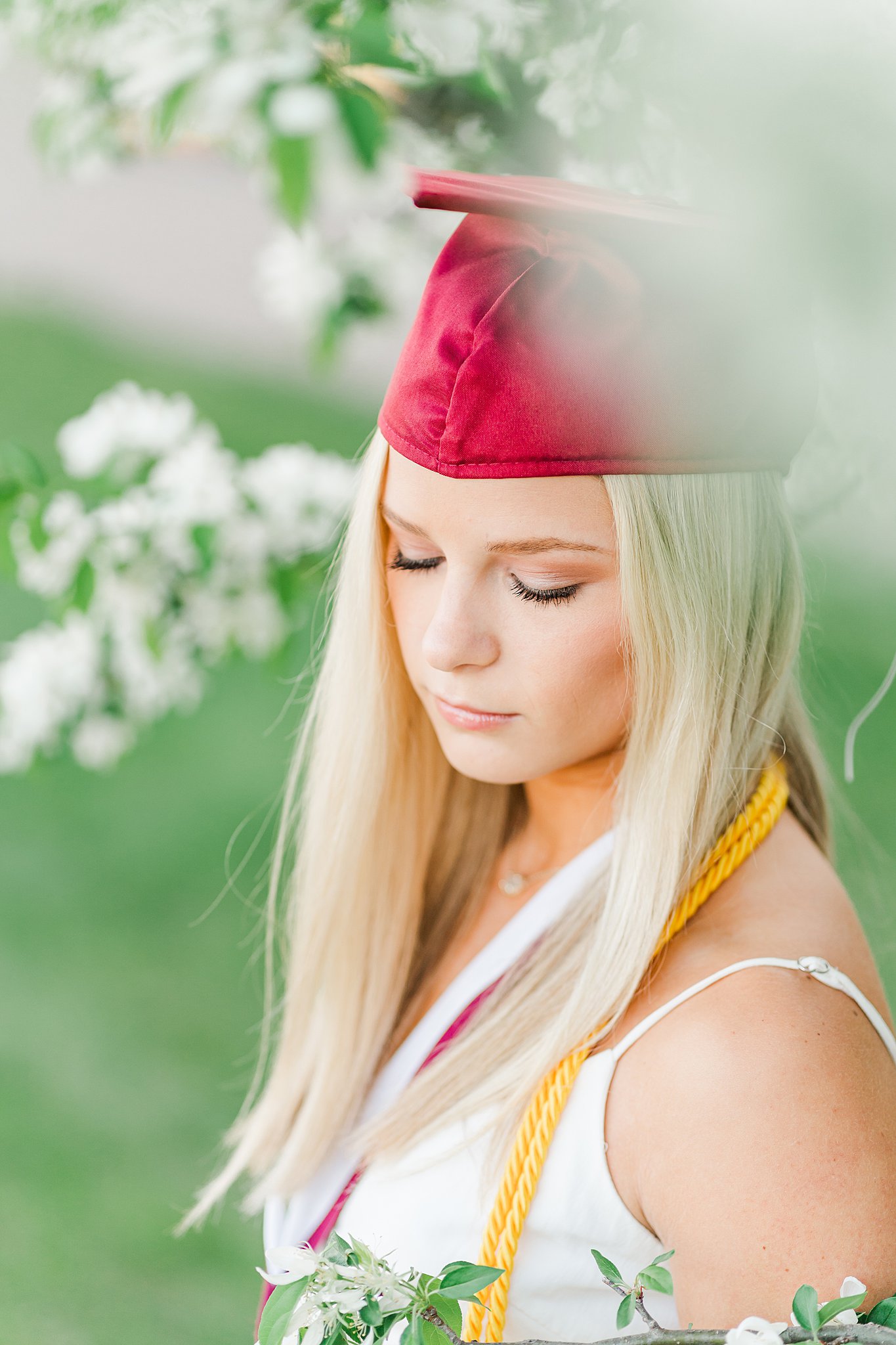 Girl looks down her shoulder wearing a graduation cap and tassles act prep rochester MN